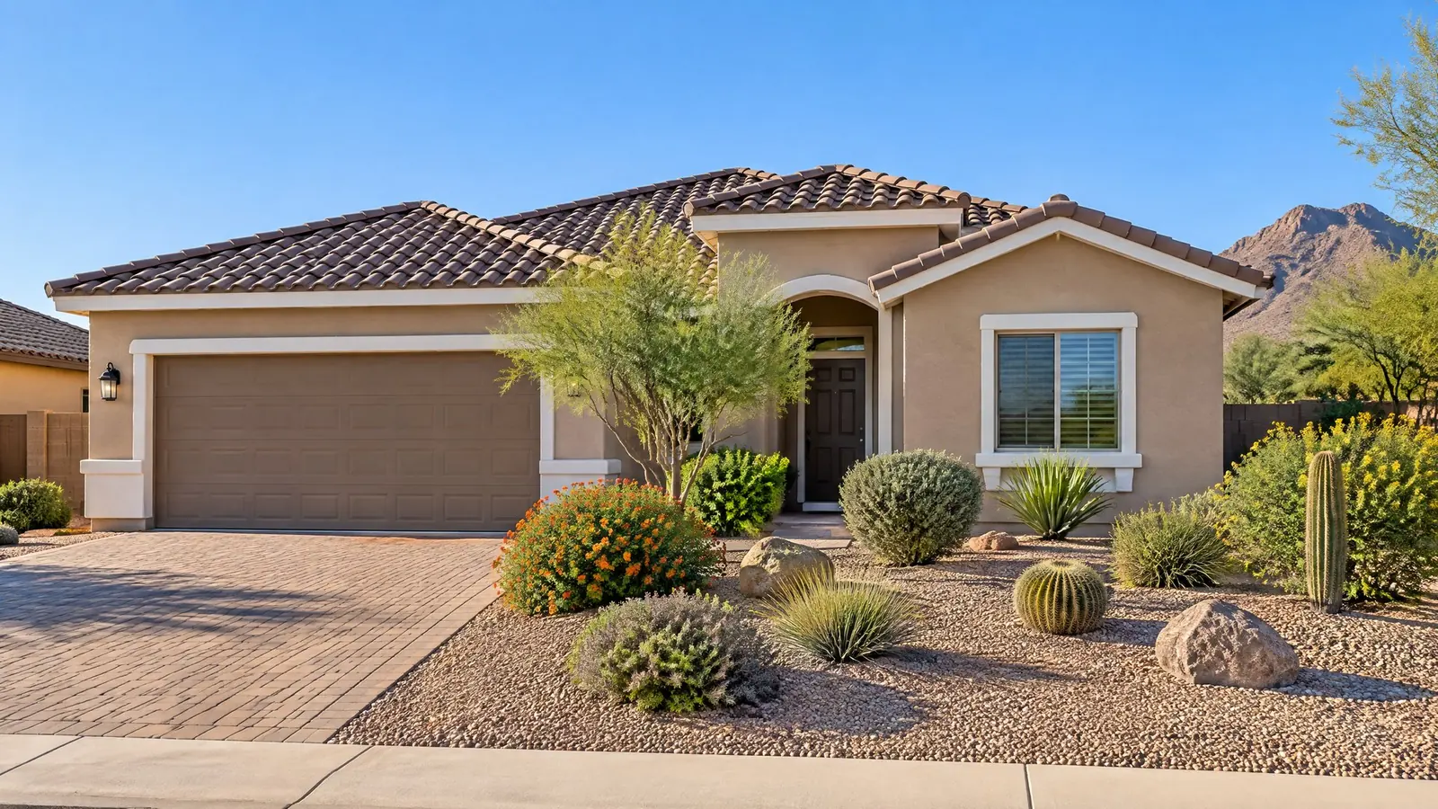 Freshly painted tan stucco home with a tile roof in Peoria, Arizona